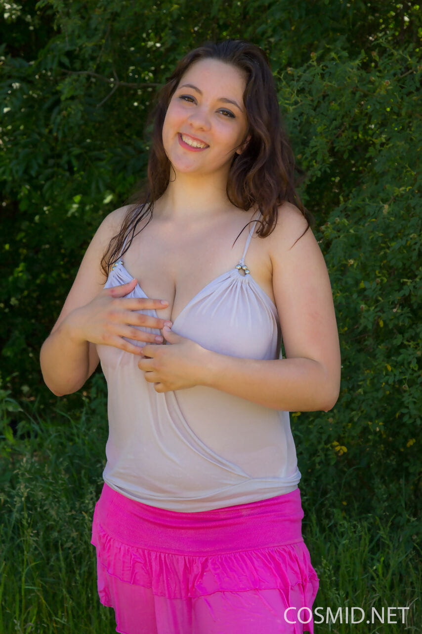 Infant female Anny Zemly pours water over her knockers in the backyard