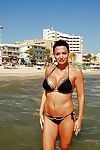 Beautiful Aletta Ocean standing outdoor on the beach in bikini