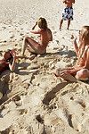Nude young teen-age angels in sunglasses having some having benefit from on the beach