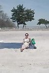 Boobsy brunette hair takes sunbath on public beach