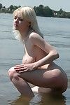 Elegant golden-haired coco is caught posing unclothed on a public beach