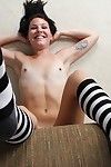 Smiley juvenile in striped knee socks undressing and exposing her hairless gash