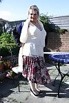 Excited seasoned lady undresses in her garden