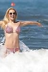 Michelle hunziker curvy in a diminutive pink bikini at the beach