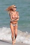 Jemma lucy shows off her vast entered milk cans at a beach