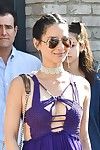 Olivia munn showing milk cans in a plunging purple costume