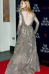 Elle fanning braless in a observe throughout lace costume