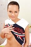 Sweetly fascinating cheerleader undressing and toying her skinhead gash