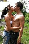 Sexual teen brunette hair erotic dance and giving a kiss with her associate outdoor