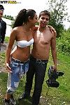 Sexual teen brunette hair erotic dance and giving a kiss with her associate outdoor