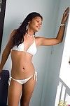 Black Indian young amplifies and pets in white bikini