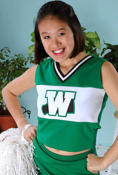 Amateur Oriental freeing big tits and ass from beneath cheerleader uniform