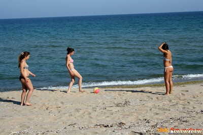 2 young looking girls jack off afterward going topless at the beach