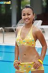 Bikini barely covers perky Asian tits and bubble booty