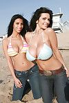 Big titted hotties posing on the beach in jeans and bikinis