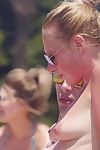 Clammy babe rubbing sun oil into her breast