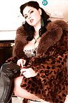 Sticky babe in furs and boots stripping and showing her enormous boobs