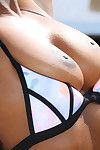 Ebony dime Lexi Rose freeing large typical ebon tits from bikini outdoors
