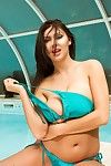 Princess brunette in blue bikini showes her boobs in the pool