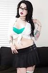 Tattooed goth chick strutting solo in pleated skirt and over the knee socks