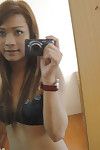 Brunette Asian shemale Aum spreading her buttocks and stroking her pride