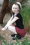Tattooed fairy girl Symone posing non in nature\'s garb outdoors in pleated skirt