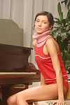Seductive young juvenile playing with herself by the piano