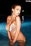 Busty solo model Ellis Attard posing for photos in swimming pool at night