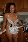 Experienced golden-haired lady Ivee showing off thong adorned butt in kitchen