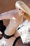 Amazingly lovely blonde in brown nylons exposing her slim curves outdoor
