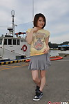 Young Japanese girl Miki Uemura poses on non nude in a skirt on a dock