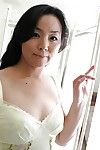Playful MILF Takako Nishazawa revealing her small tits with raw boob points