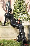 Fetish babe Lucy Latex posing and jerking off her cunt outdoor