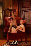 Corseted fixation babe Emily Marilyn strips down to revealing lingerie and sheer stockings