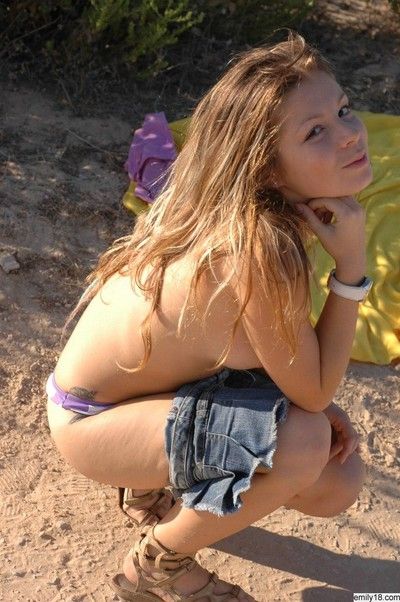 Pretty teen girl in jean skirt outdoors